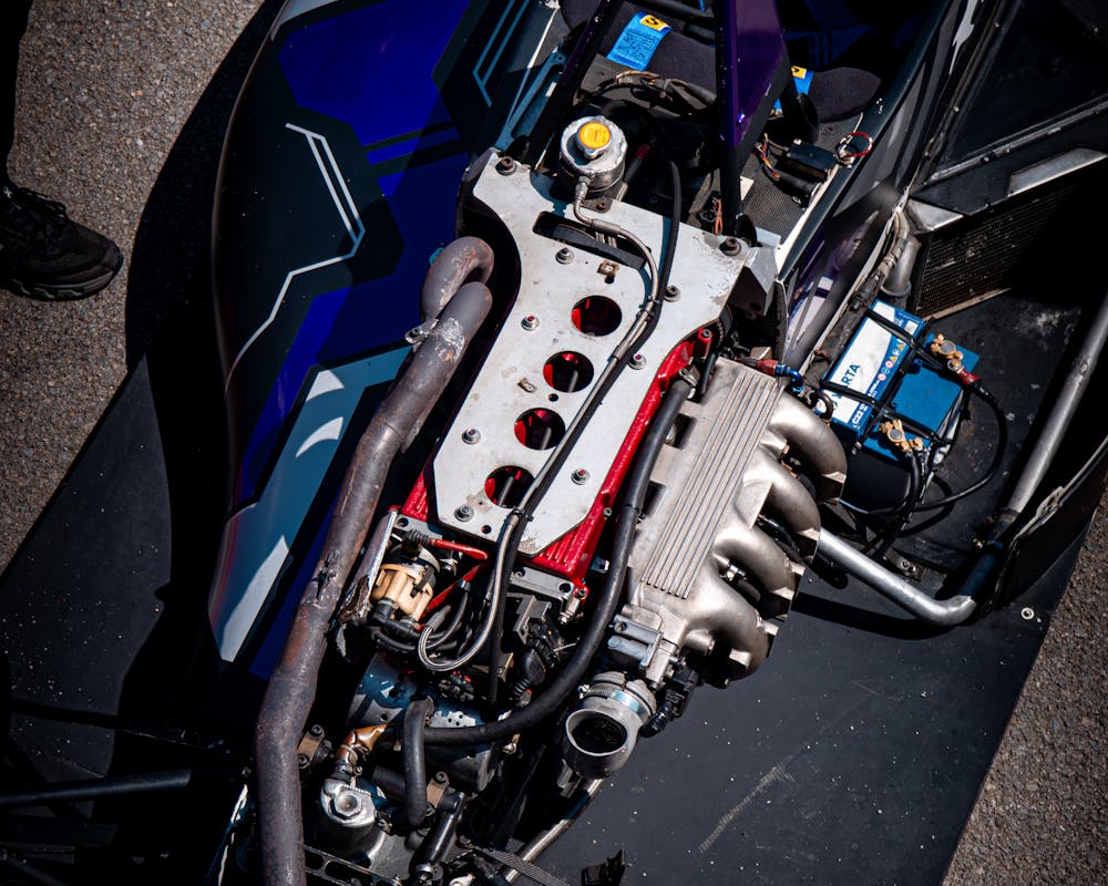 The engine bay of a single-seat race car, mechanical detail